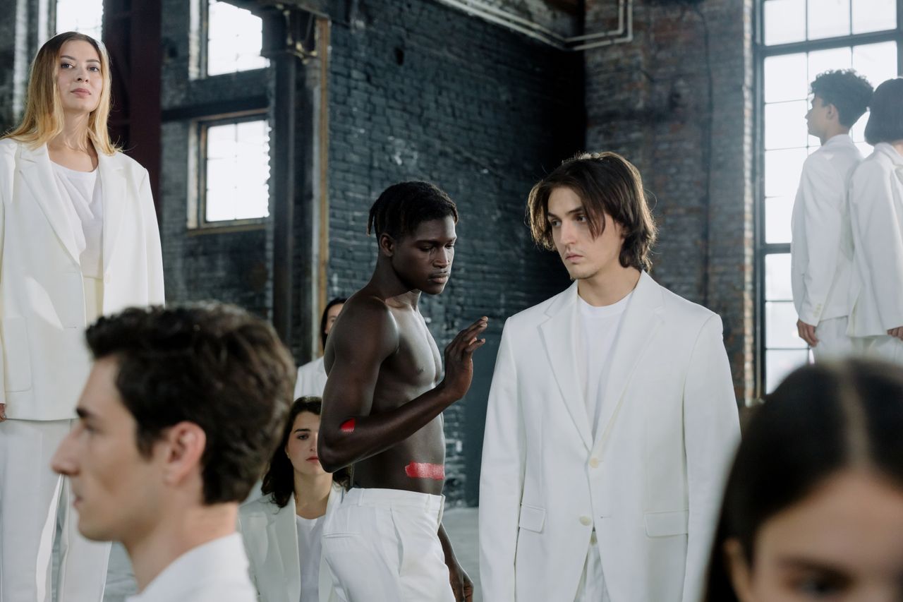 Home Models in a fashion shoot wearing white outfits in an industrial space.