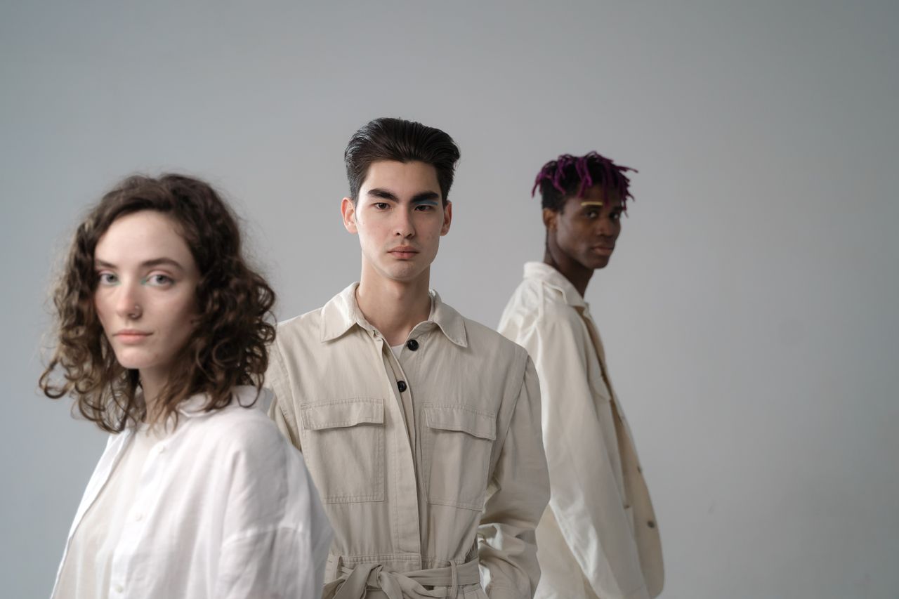 Mastering the First Impression: Your intriguing post title goes here Group of diverse multiethnic young people wearing light beige and white cotton clothes standing in studio and looking at camera on gray background